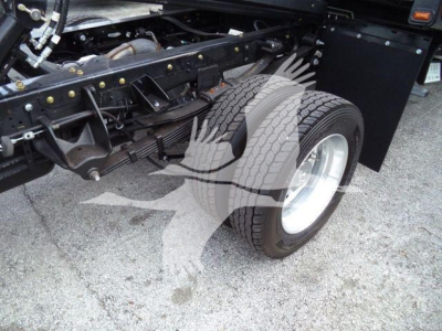 Ram 5500 rollback truck rear suspension and dual rear wheels showing solid frame and tire treads.