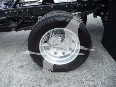 RAM truck chassis with wheel and tire, metal suspension framework visible.