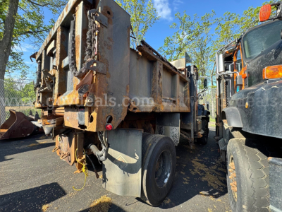 Dump truck bed of a 2004 International 5600i with visible rust and towing chain.