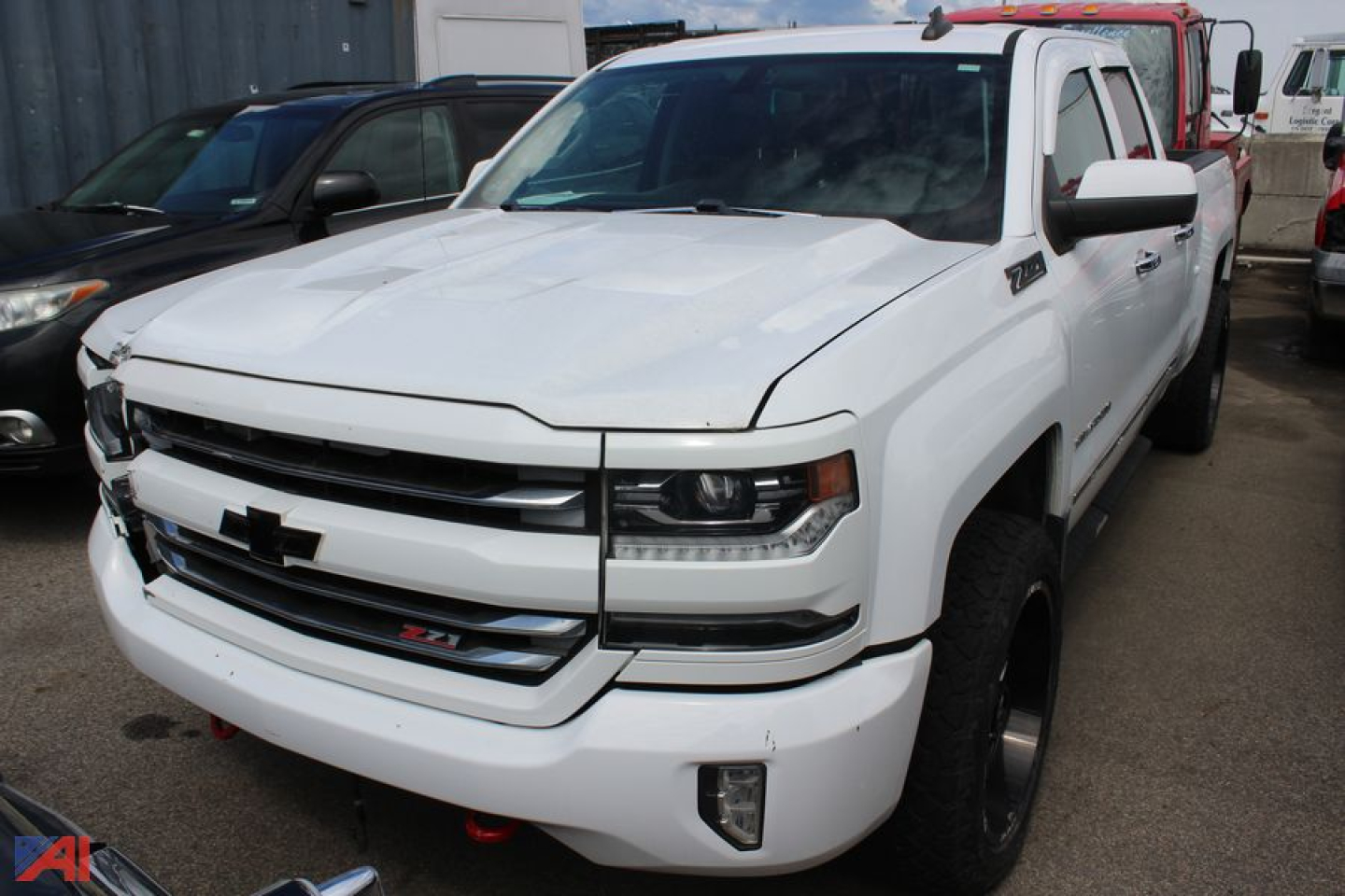 Chevrolet Silverado 1500 pickup (2018) front-left view; white exterior; 4x4 Z71 badge visible; partial dealership lot in background.