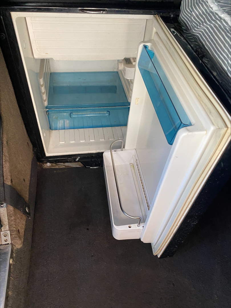 Kenworth W900L storage fridge/freezer compartment in cab with open small cooler drawer visible