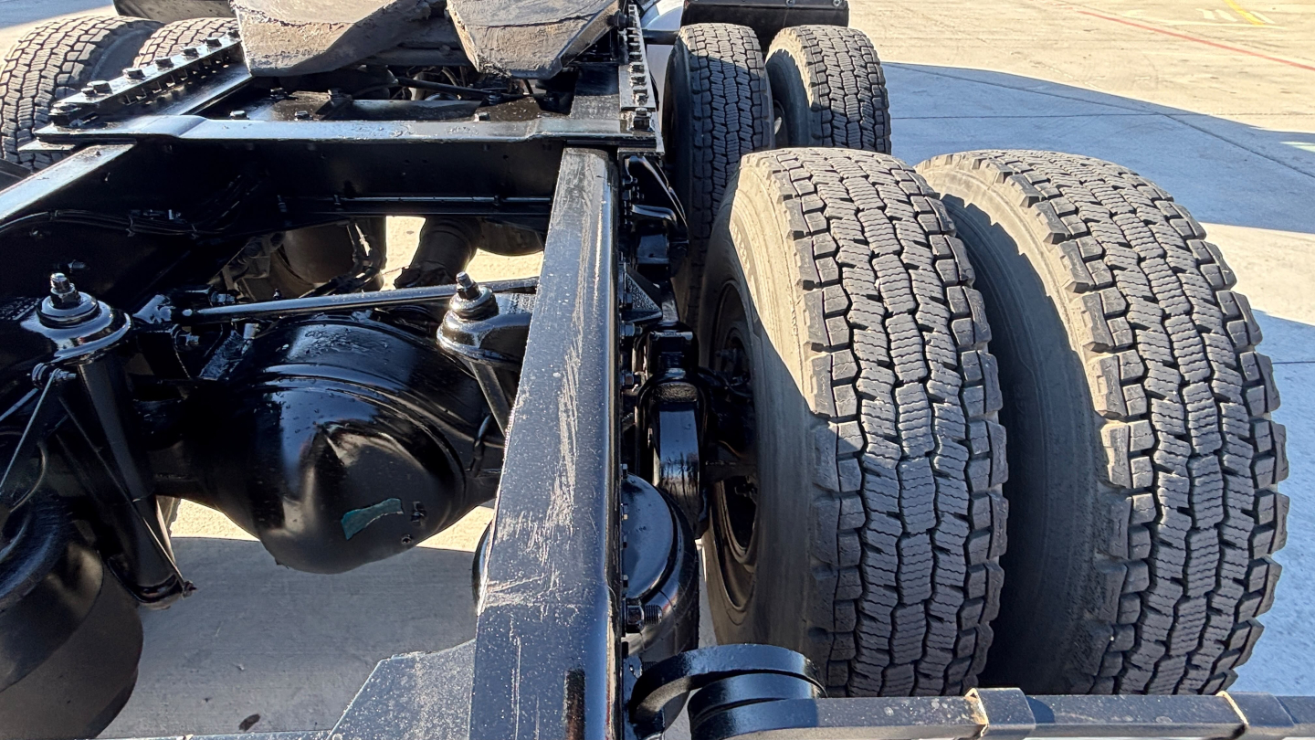 Kenworth T880 chassis showing rear dual rear wheels and differential housing, with visible suspension components and frame rails