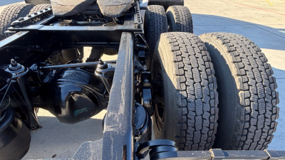 Kenworth T880 chassis showing rear dual rear wheels and differential housing, with visible suspension components and frame rails