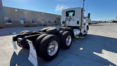 Kenworth T880 tractor–rear view showing fifth wheel and dual rear axles with white cab.