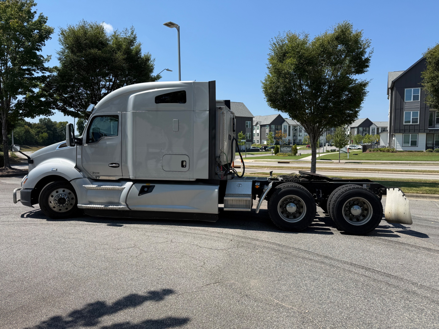 Kenworth T680 semi-truck tractor in profile view with sleeper cab, dual rear axles, and chrome fuel tanks.