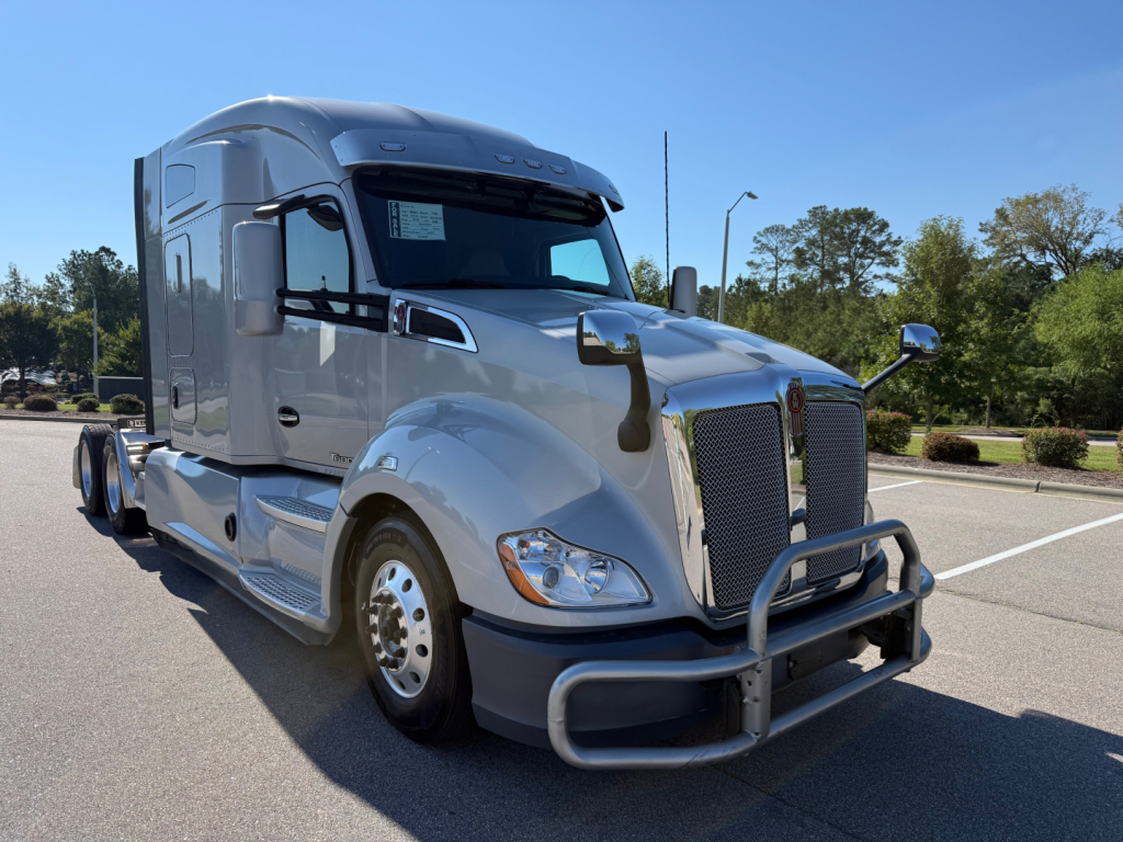 Kenworth T680 semi-truck front-left view, chrome grille guard, silver cab with attached sleeper, no visible labels.