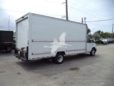 Ford E-350 box truck with cargo body, rear Roll-up door, white paint, logo of a bird on side, side view showing cargo box and truck cab.