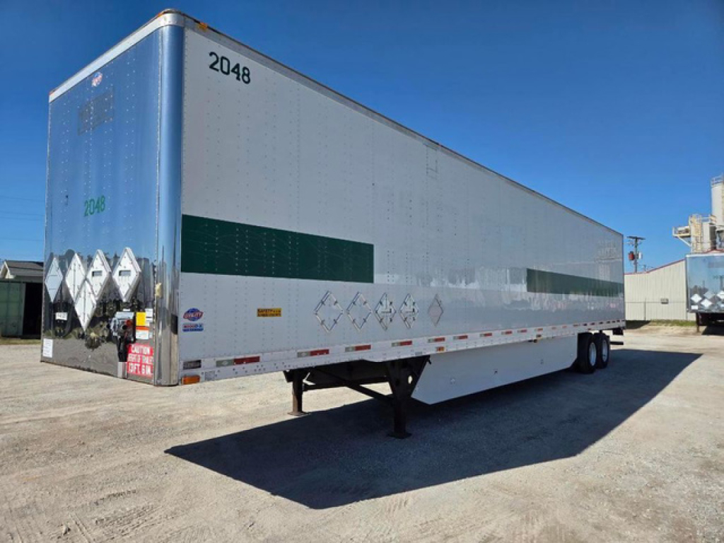 Trailer side view showing 2048 number, rear doors with diamond placards, undercarriage, and support legs.