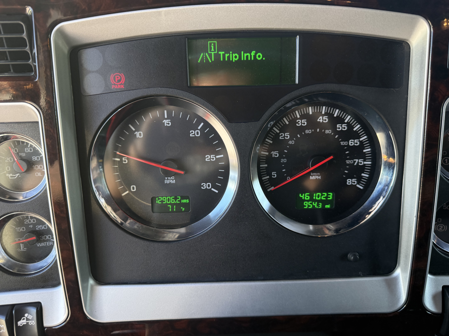 Kenworth W900L instrument cluster showing tachometer and speedometer with trip display and VIN-related dashboard.