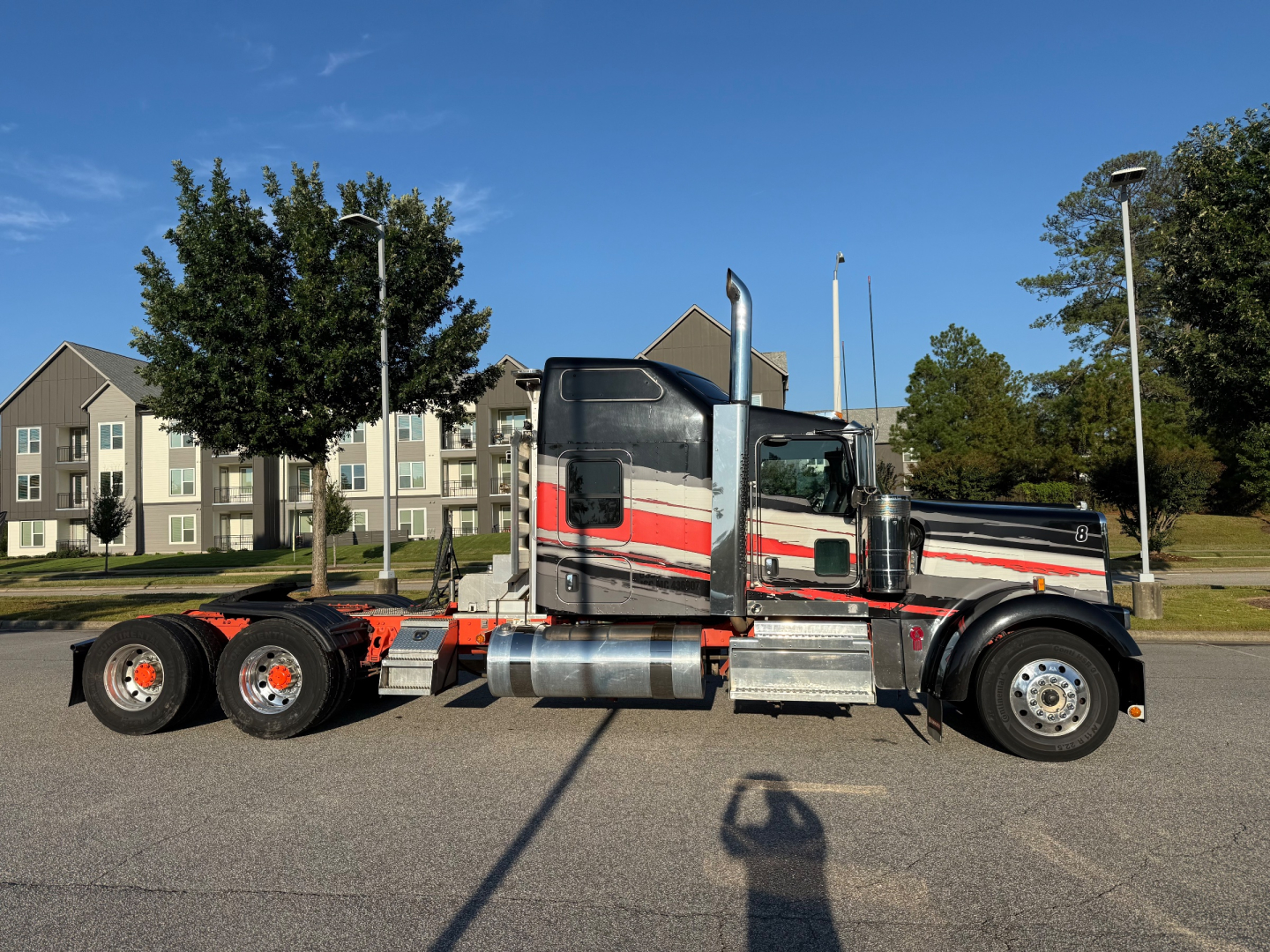 Kenworth W900L tractor-trailer profile showing side view with chrome fuel tanks and dual rear axles.