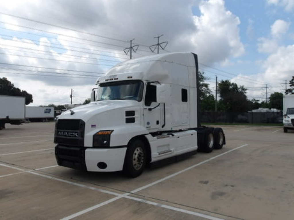 Truck cab of a white 2020 Mack Anthem conventional sleeper tractor in a parking lot, visible VIN and stock number not shown on image.