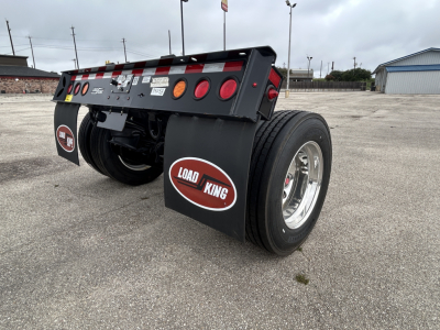 Load King trailer rear view showing 60 ton flip axle and dual wheels with Load King mud flaps and LED taillights.