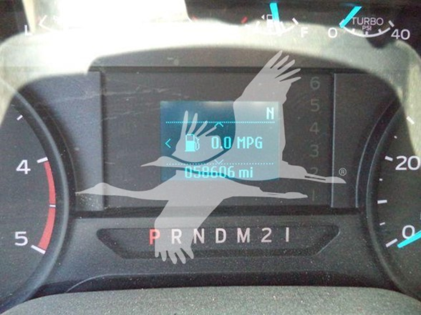 Dashboard of a Ford F-250 showing 0.0 MPG display and odometer reading 58,606 miles with gear shift indicator PRNDM2I.