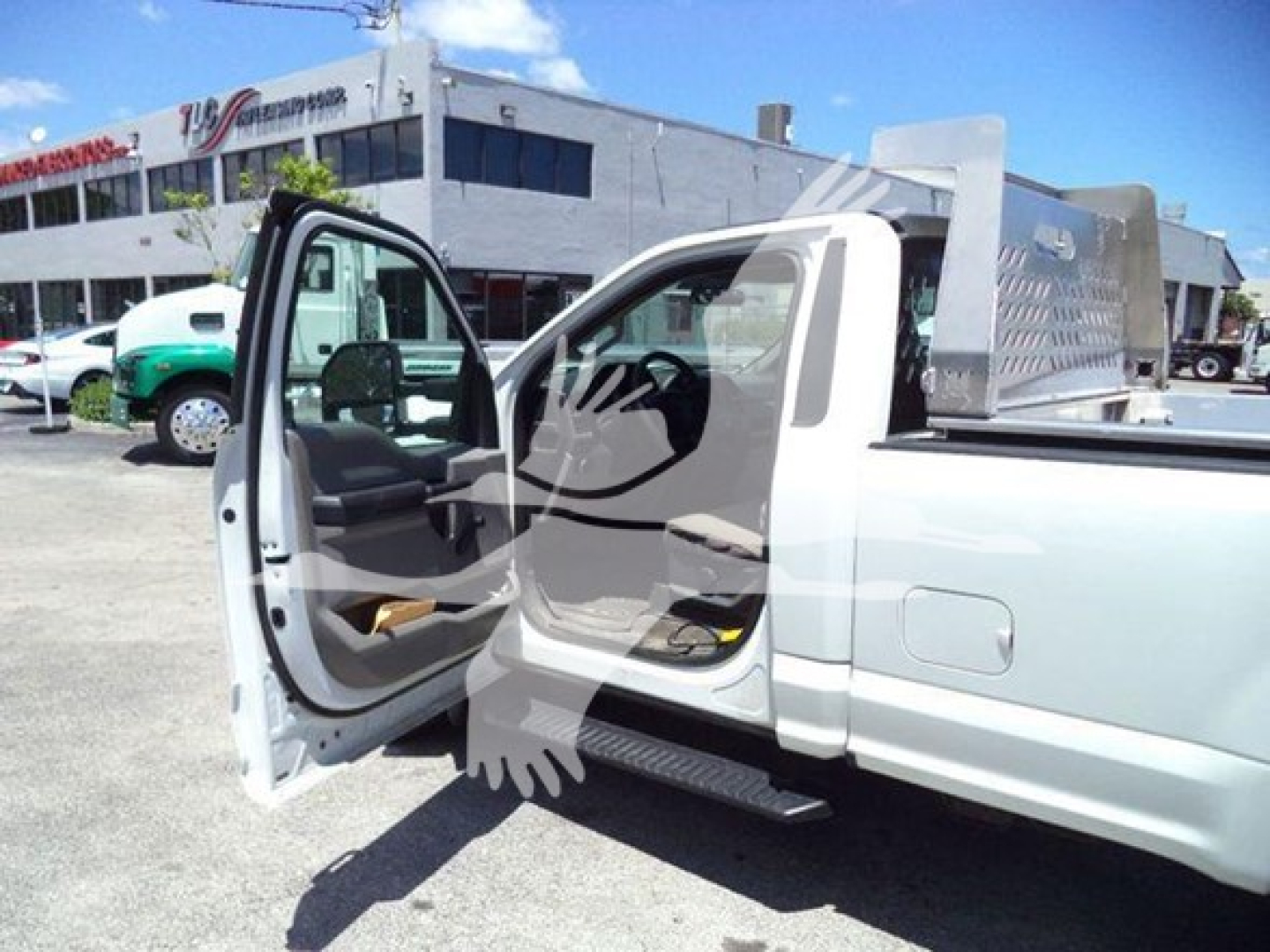 2017 Ford F-250 dump truck with front passenger door open, showing aluminum checker plate toolbox in bed and cab interior.