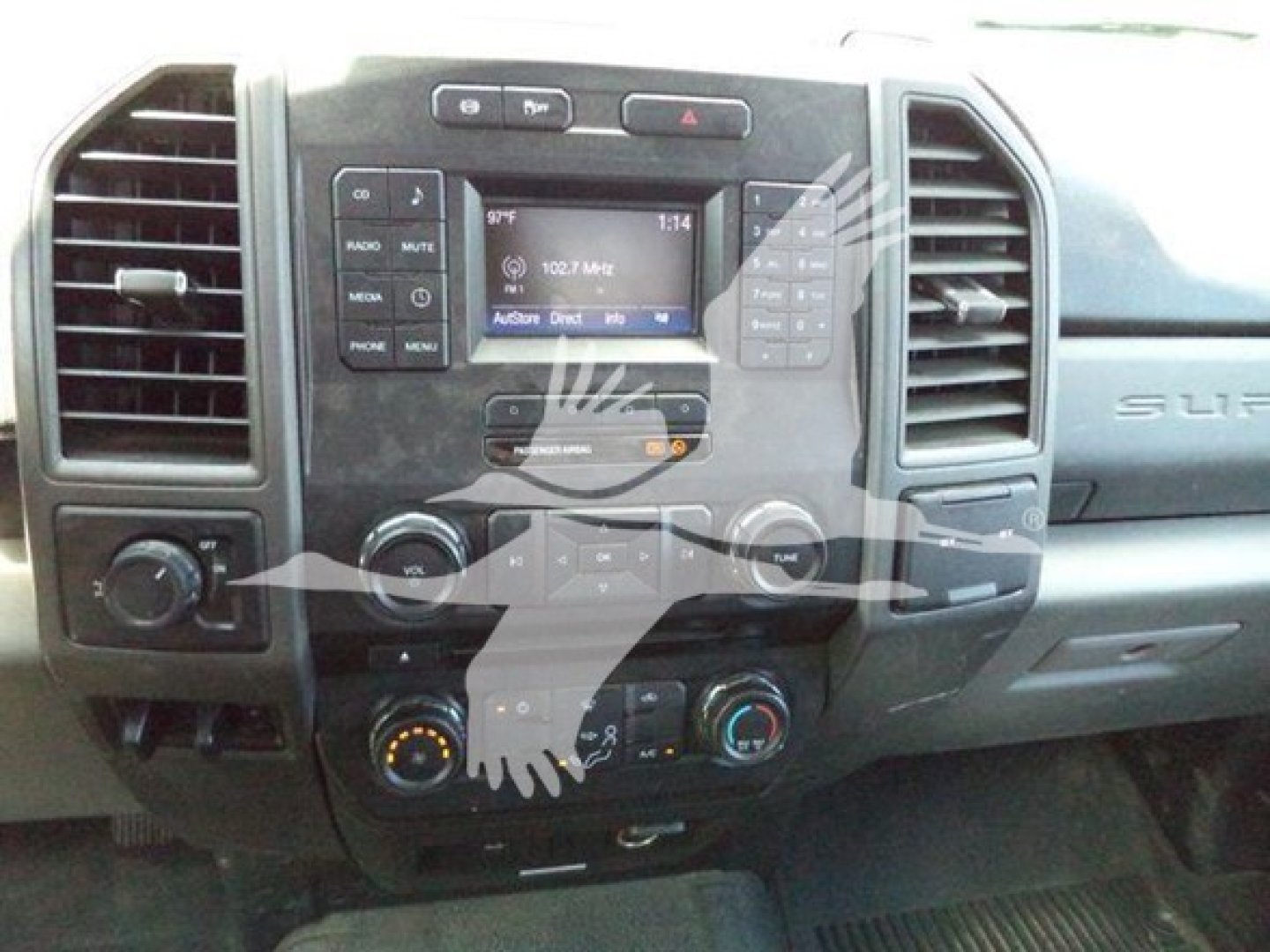 Dashboard of a 2017 Ford F-250 with center console controls, radio display showing 102.7 MHz, climate controls, and vents.