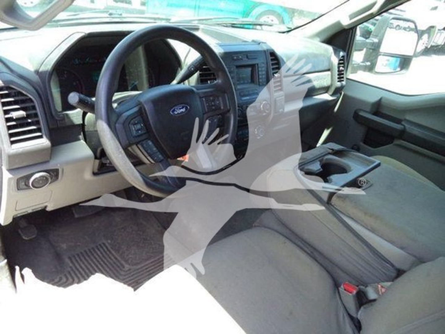 Interior of a Ford F-250 truck showing steering wheel, dashboard, center console, and front seats.