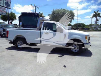 2017 Ford F250 white dump truck side view with bed and toolbox visible