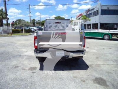 Rear view of a Ford dump truck bed with VIN sticker and stock number visible.