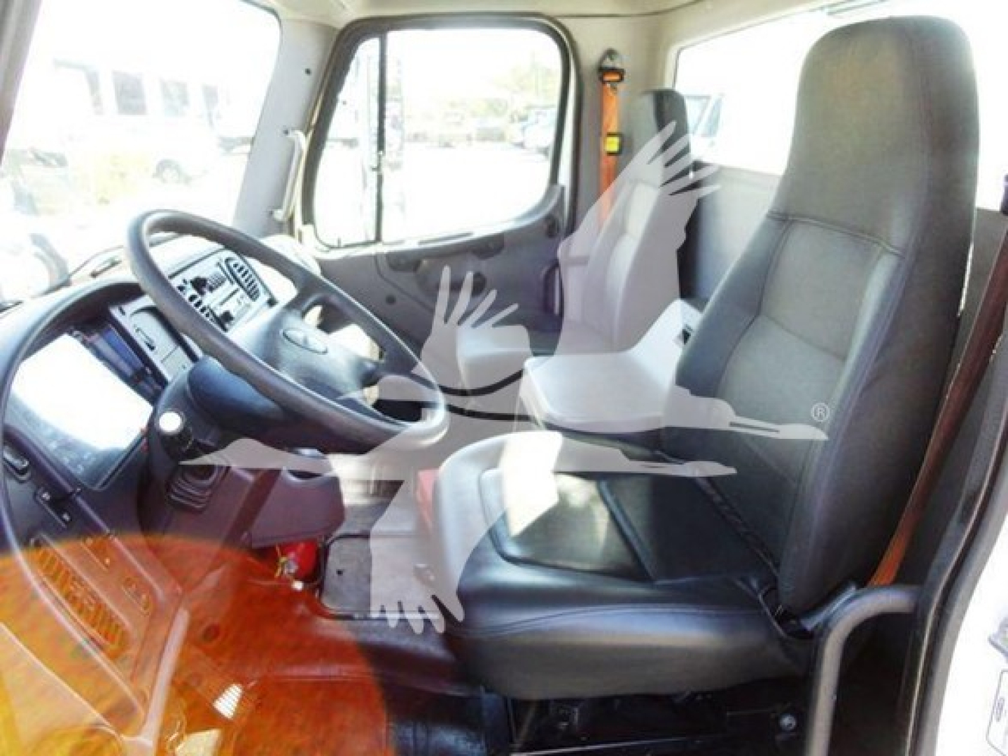 Cab interior of a 2012 Freightliner Business Class M2 106 truck showing driver seat and steering wheel with dashboard