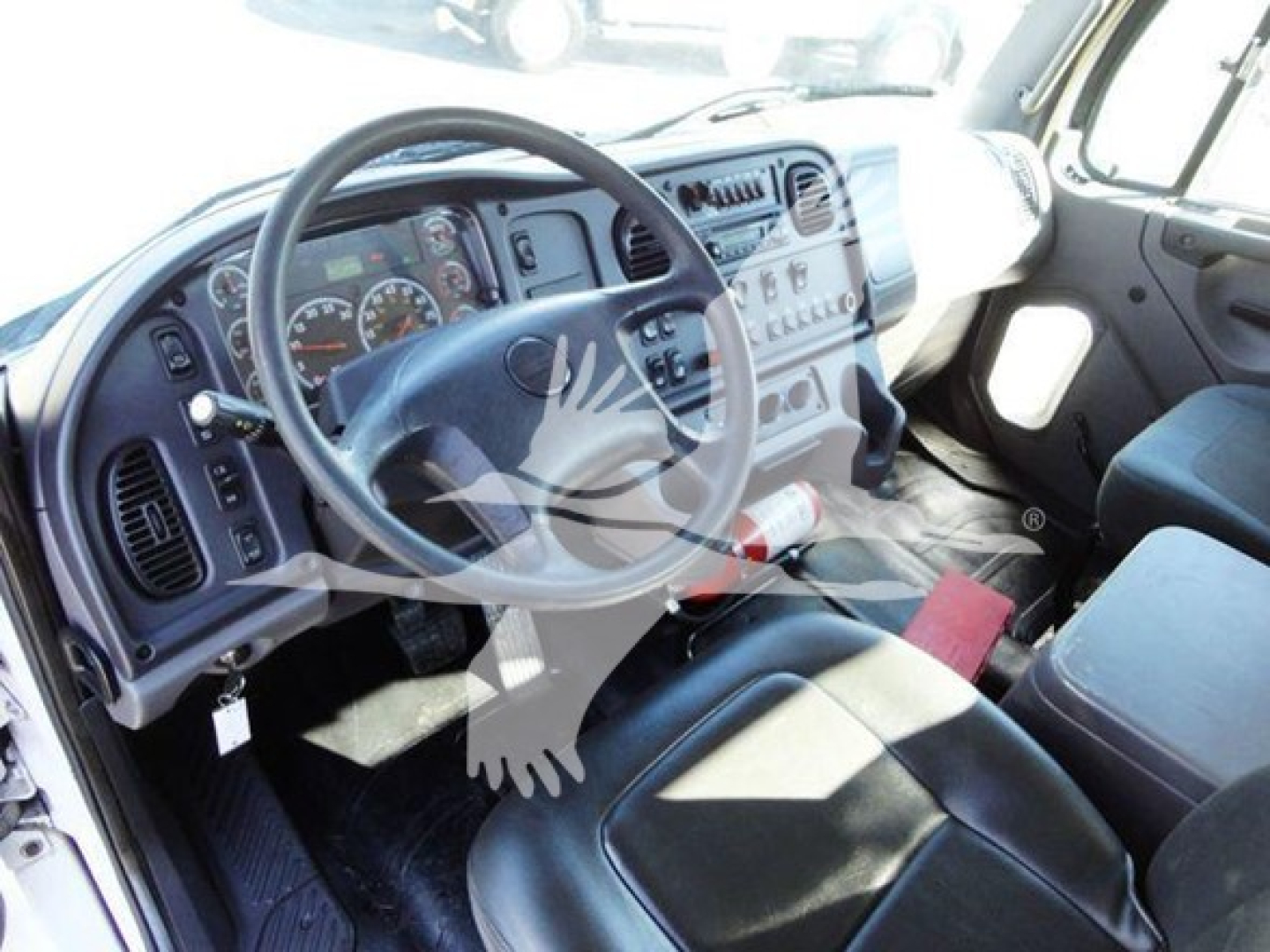 Freightliner Business Class M2 106 interior showing steering wheel, instrument cluster, and dashboard with controls.