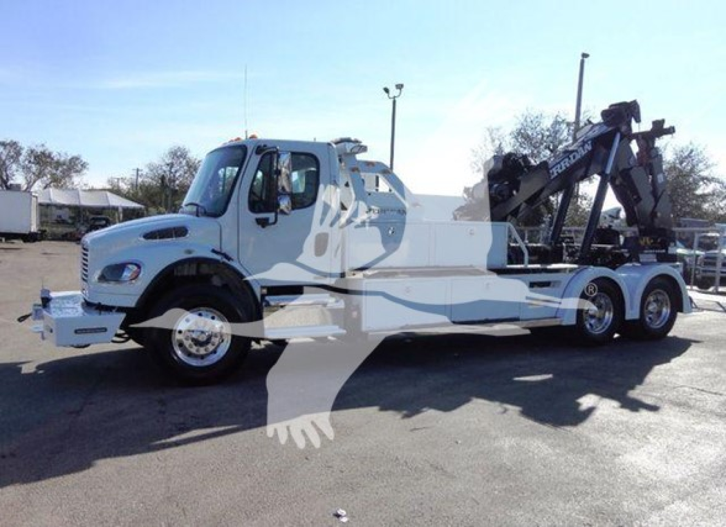 Freightliner Business Class M2 106 tow truck with crane, side view showing cab, chassis, and rear winch crane assembly.