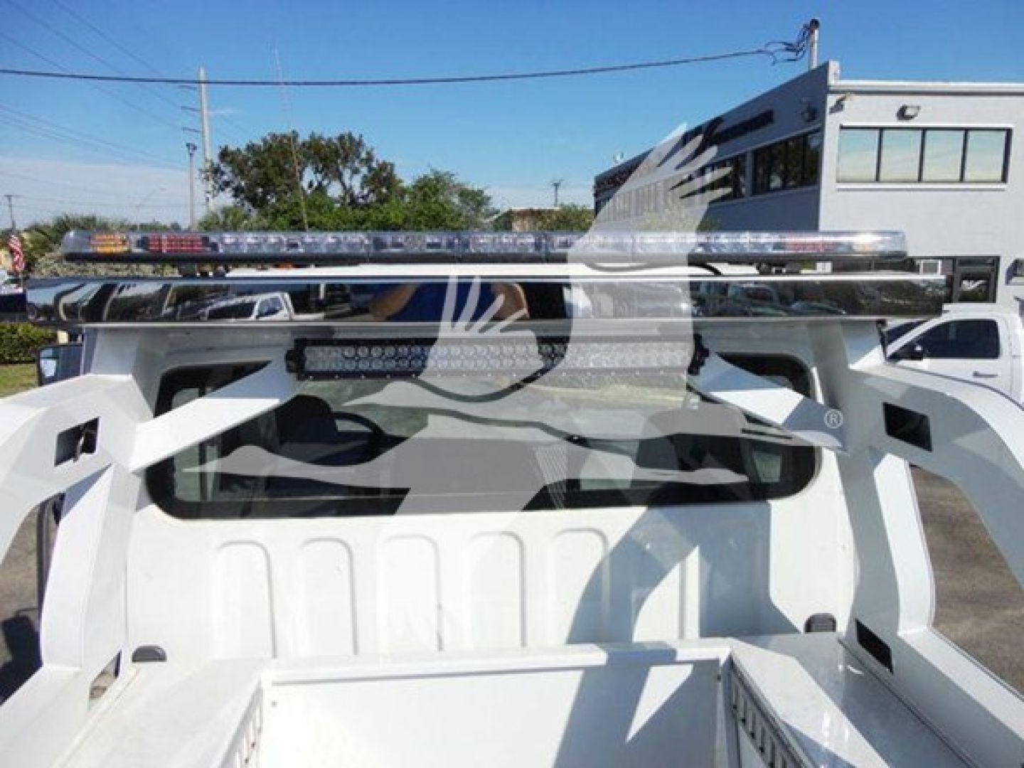 Truck bed with winch equipment mounted on Freightliner Business Class M2 106 chassis showing dual light bar and metal rails.