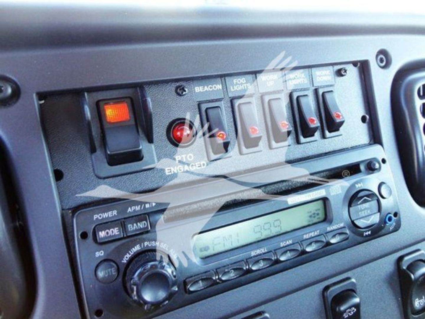 Dashboard cab controls and radio panel of Freightliner Business Class M2 106 showing switches and radio display.