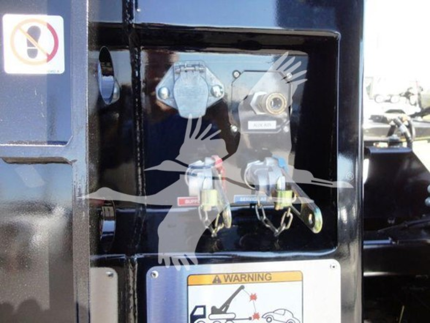 Winch controls panel on Freightliner M2 front with warning label and hydraulic fittings.