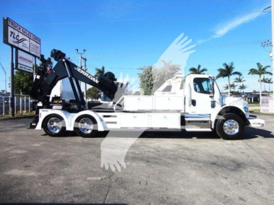 Freightliner Business Class M2 106 truck with mounted crane/winch and white cab and body, side view.