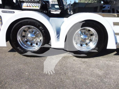 Freightliner Business Class M2 106 wheel area showing dual front tires with chrome rims and white fender flares.