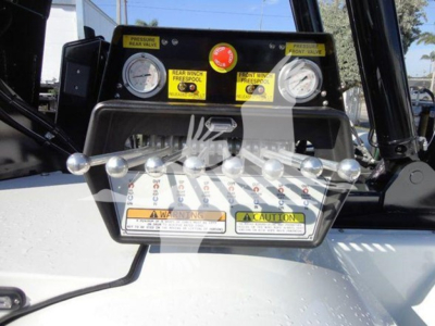 Equipment panel with dual gauges and winch controls on Freightliner Business Class M2 106. Front view of control panel with labels and switch handles.