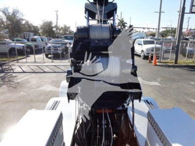 Winch-equipped 2012 Freightliner Business Class M2 106 truck in yard with winch drum and cables visible in foreground.