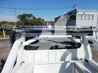 Truck bed of a Freightliner business class M2 106 with a light bar and winch setup visible in the bed.