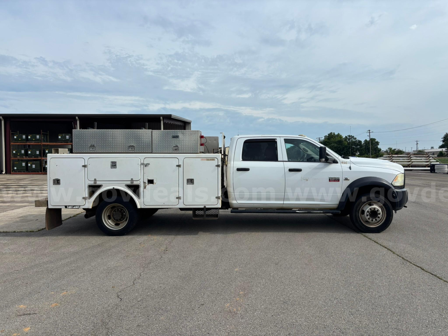 Dodge Ram 550 service truck side view showing utility body with multiple compartments and storage boxes.