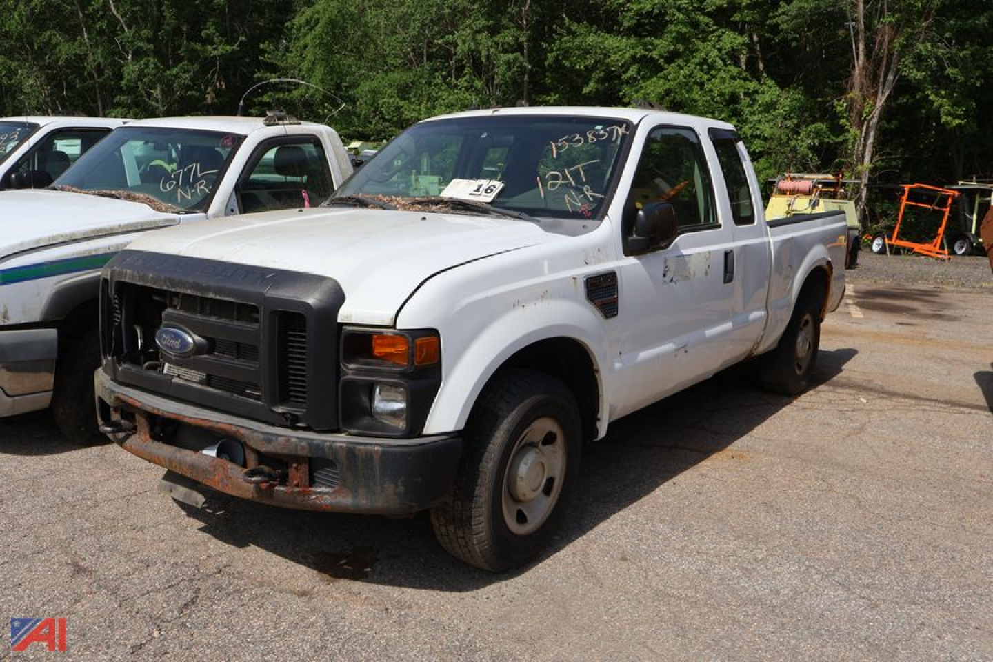 White Ford F-250 Super Duty pickup truck front-left view. Rust on bumper, black grille, single cab with long bed, standard wheels, worn headlight area.
