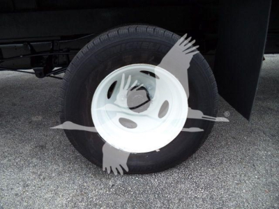Wheel of a Ford E450 cargo vehicle showing a white steel rim with black tire and a partial undercarriage. No other legible text visible.