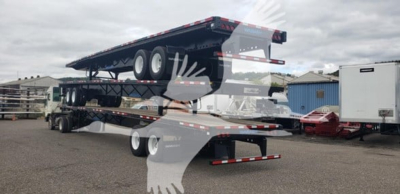 Used 2024 Wabash air slider flatbed trailer with dual decks and extendable end, on a lot. Side view shows heavy-duty wheels, tandem axles, and rear ramps.