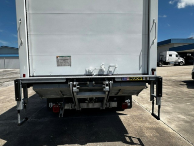 Back of 2026 Mack MD6 refrigerated truck showing liftgate with Maxon components and rear stabilizers.