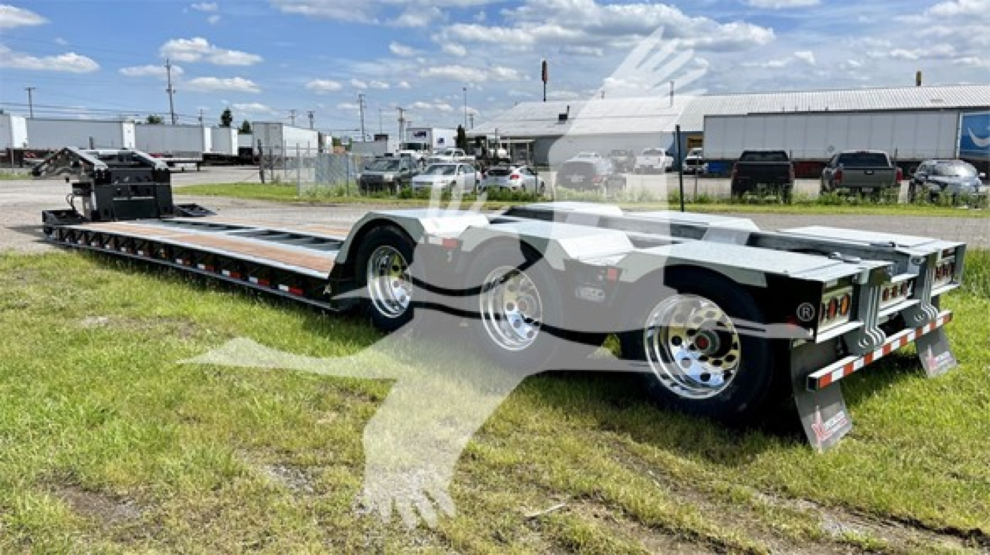 XL Specialized XL110HDGS lowboy trailer in a side view showing dual tandem axles, long deck, ramps up front, black with reflective markings and chrome wheels.