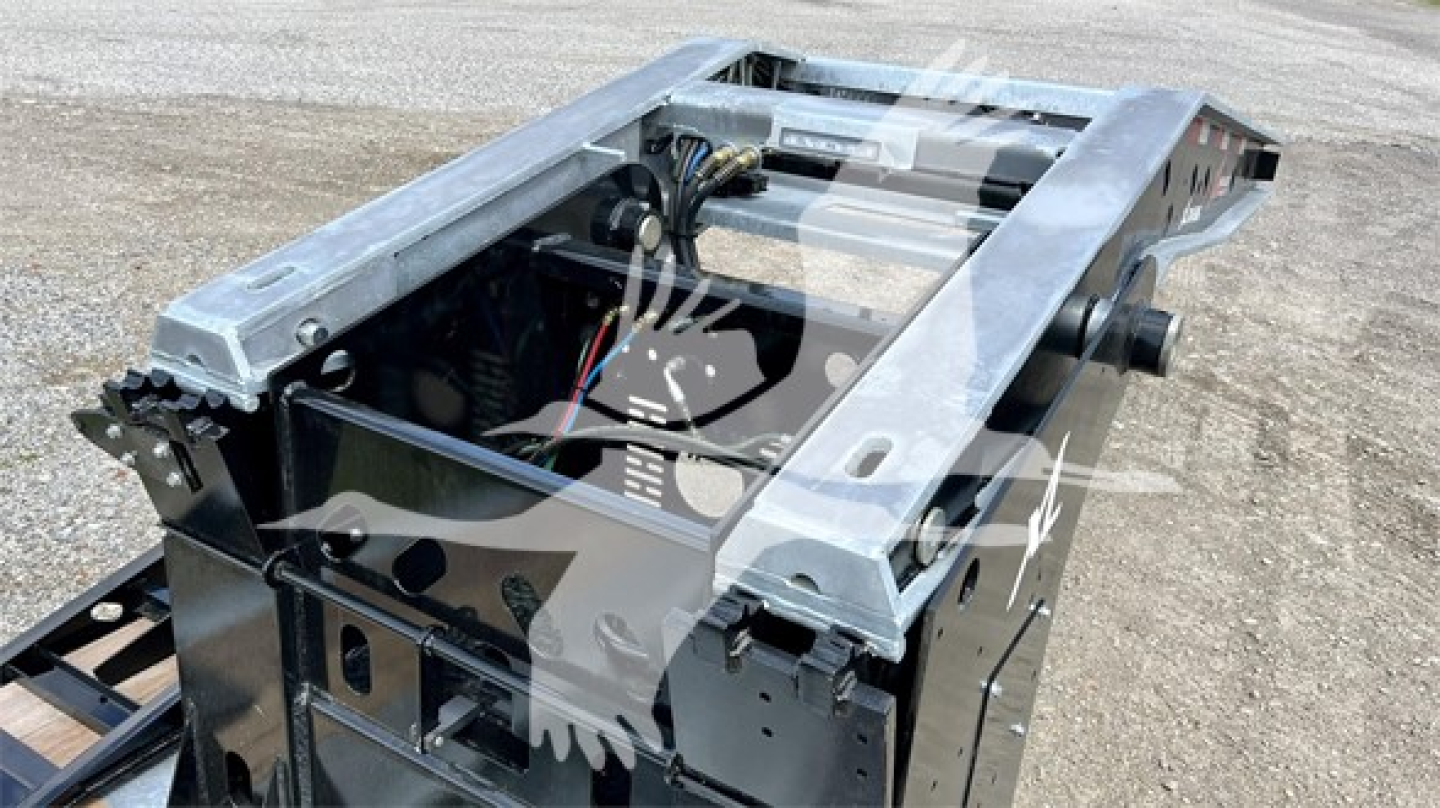 Trailer component showing metal frame and hydraulic lines in an XL Specialized XL110HDGS trailer, top view with wiring harness and structural rails visible.