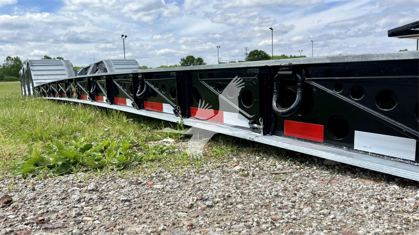 Trailer frame side view showing XL Specialized XL110HDGS lowboy trailer with black framing and red/white reflective markers.