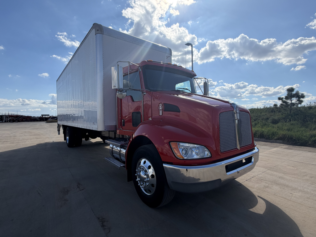 Kenworth T270 box truck with red cab and white cargo box, side view, on a clear day