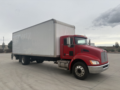 Kenworth box truck in side view showing cargo box and cab with red exterior and silver wheels.