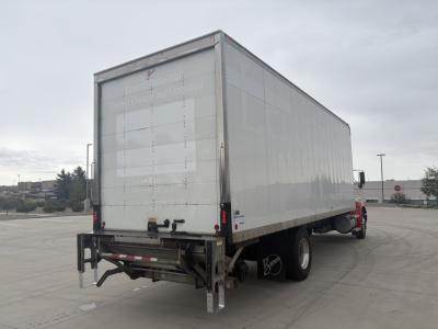 Kenworth T270 box truck rear and side view showing empty white tandem-axle box with tailgate and rear underride guard.