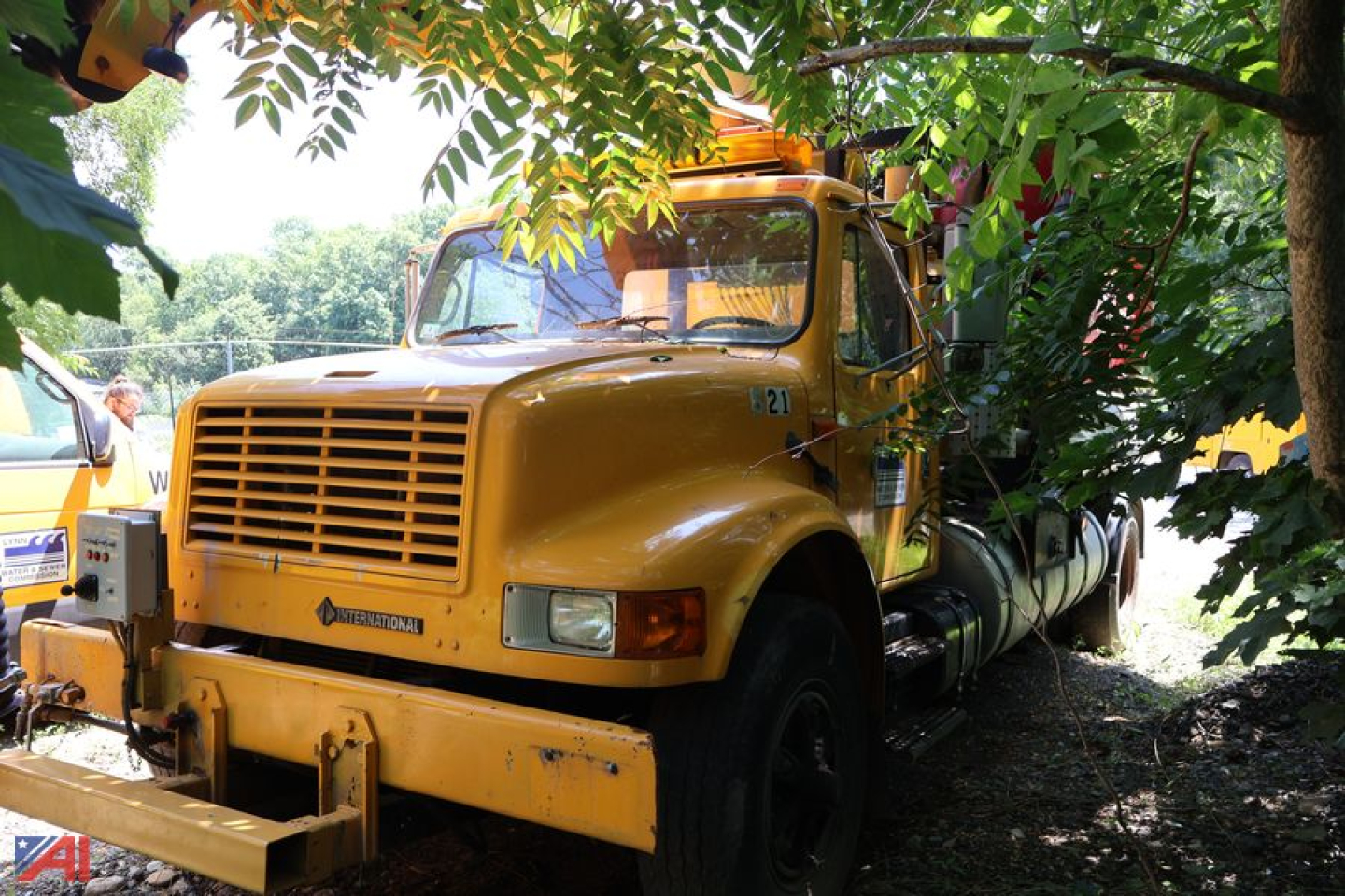 International 4900 Vactor truck in yard showing front grille and yellow cab with equipment attached