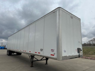 Wabash dry van trailer, 53 ft, side view showing front and underride legs with serial and warning labels barely visible.