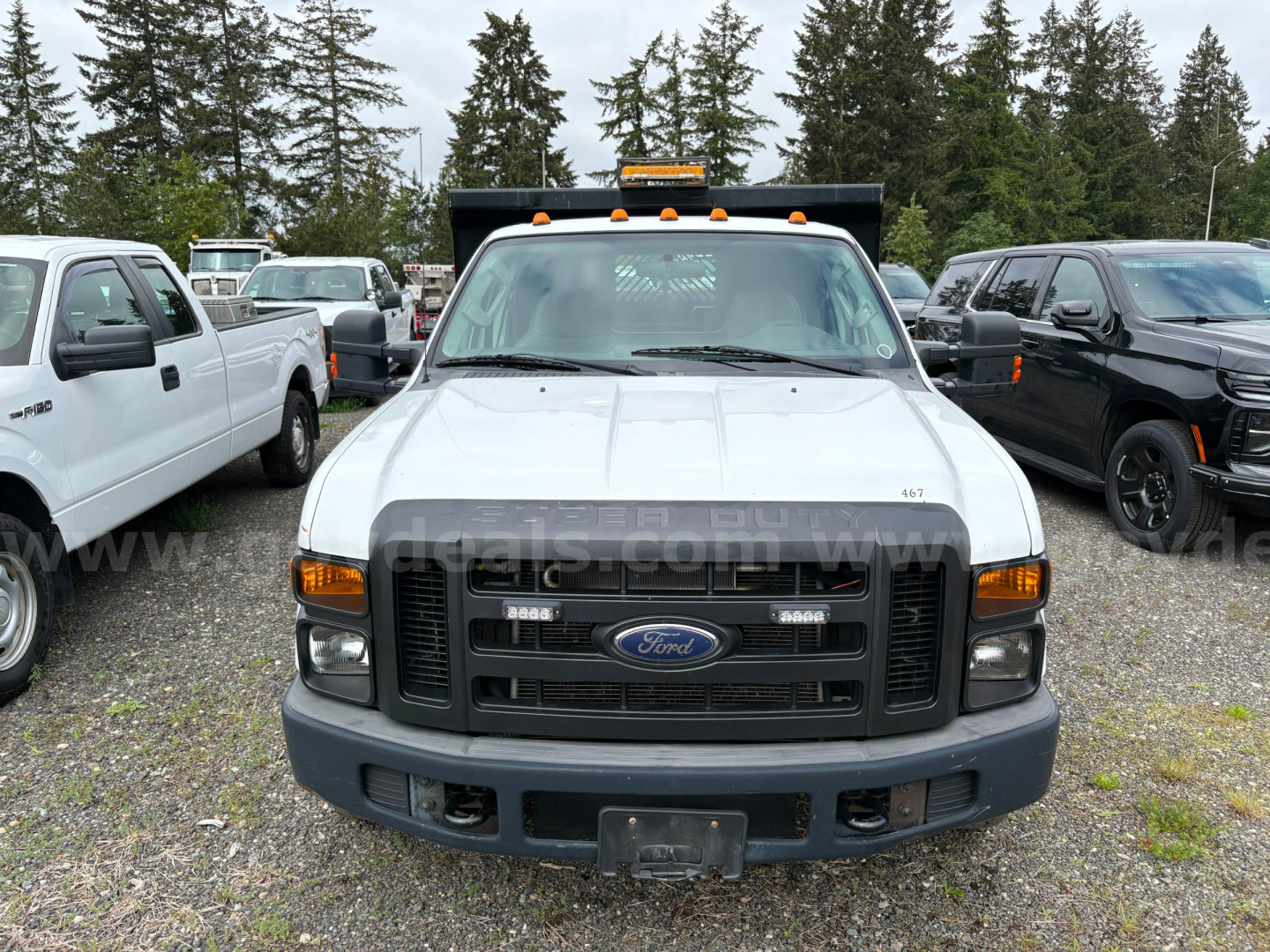 Ford F-350 dump truck front view showing grille with Ford emblem and bumper, with amber clearance lights on cab roof.