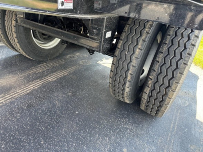 Trailer rear showing dual rear axles with tires and undercarriage components visible
