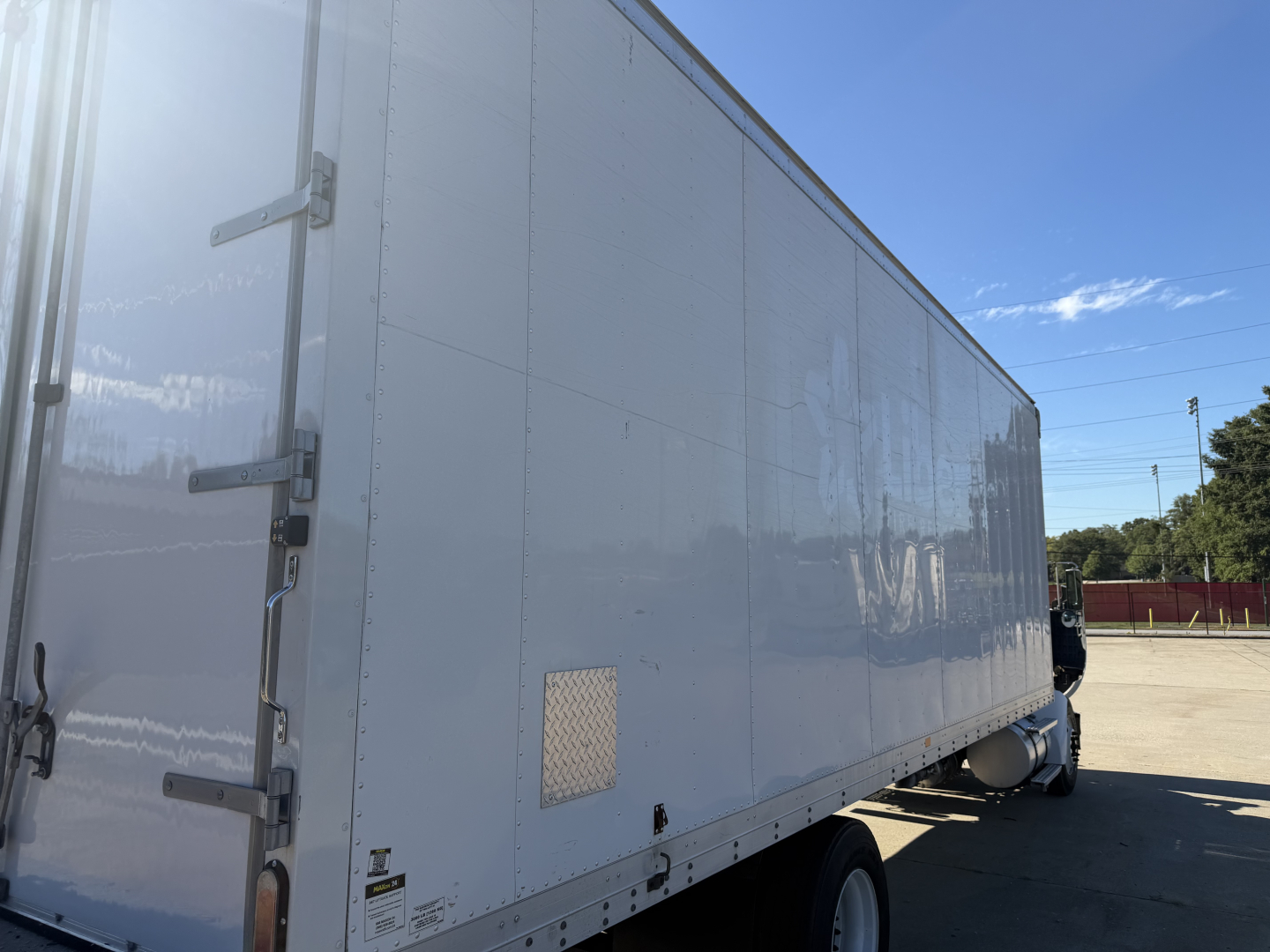 Kenworth T270 box truck side view showing large cargo box and white exterior.