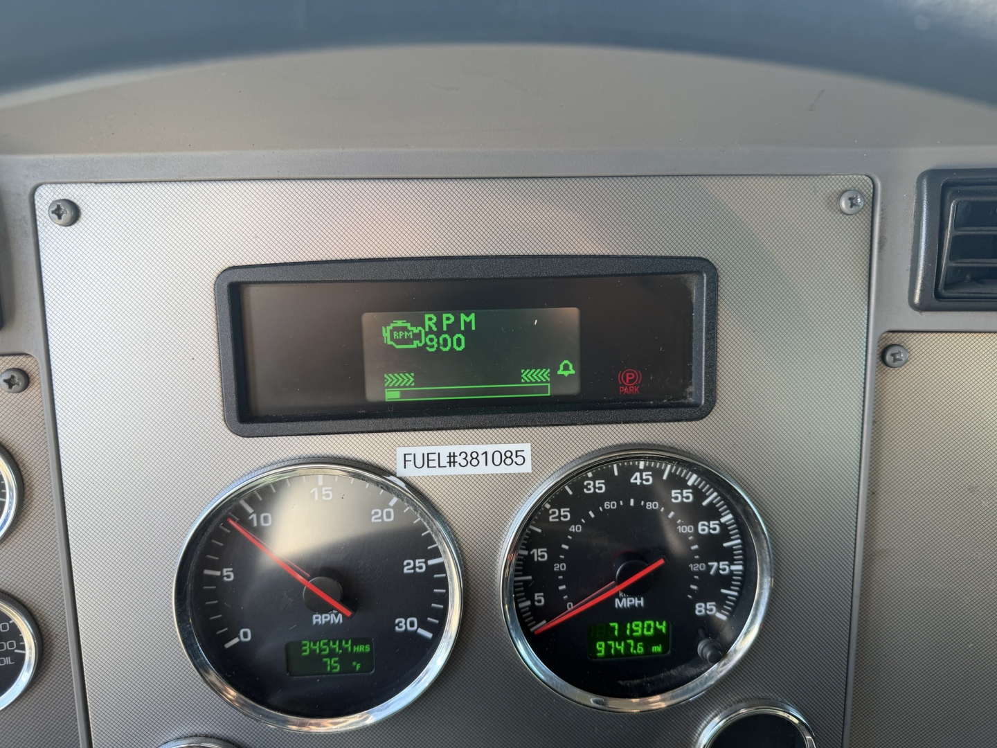 Dashboard panel of a 2023 Kenworth T270 showing RPM gauge and speedometer with digital displays and a small screen at top displaying RPM and status icons.